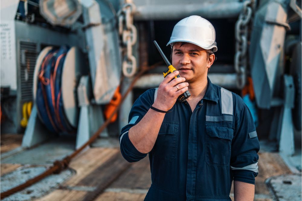 a guy holding VHF walkie-talkie radio in hands