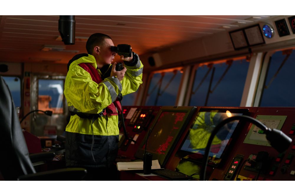 a ship crew performing daily duties with VHF radio, binoculars on board of modern ship